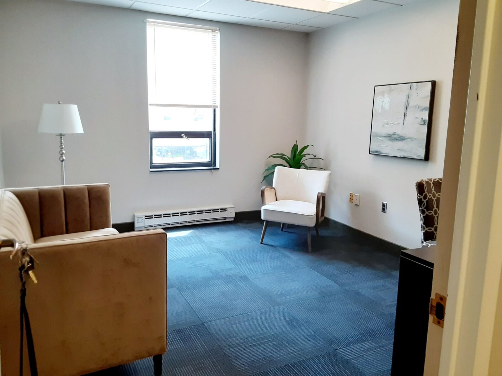 Private office with guest seating at Premier Business Suites